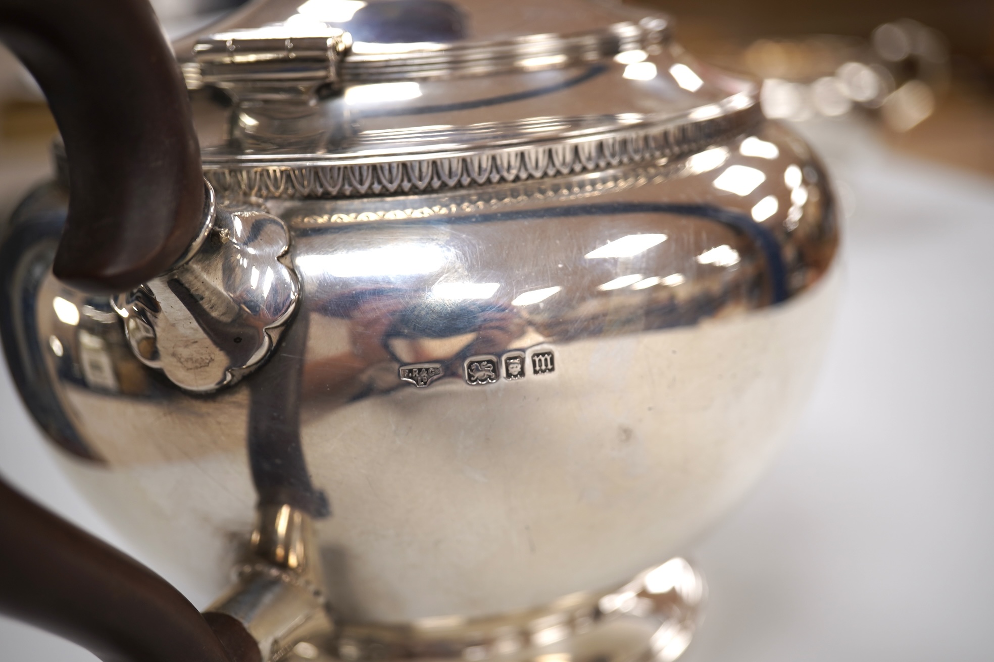 A George V silver circular three piece tea set, with engraved initial, Fenton, Russell & Co Ltd, London, 1927, gross weight 32.4oz.